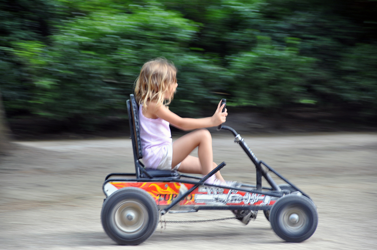 Kate Borson riding a go cart in Paris Park